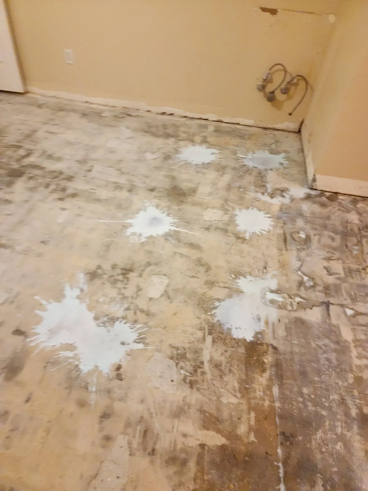 Subfloor with patched spots after old flooring was removed