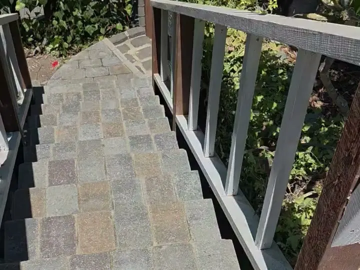 Outdoor stairs with paver treads between wood railings