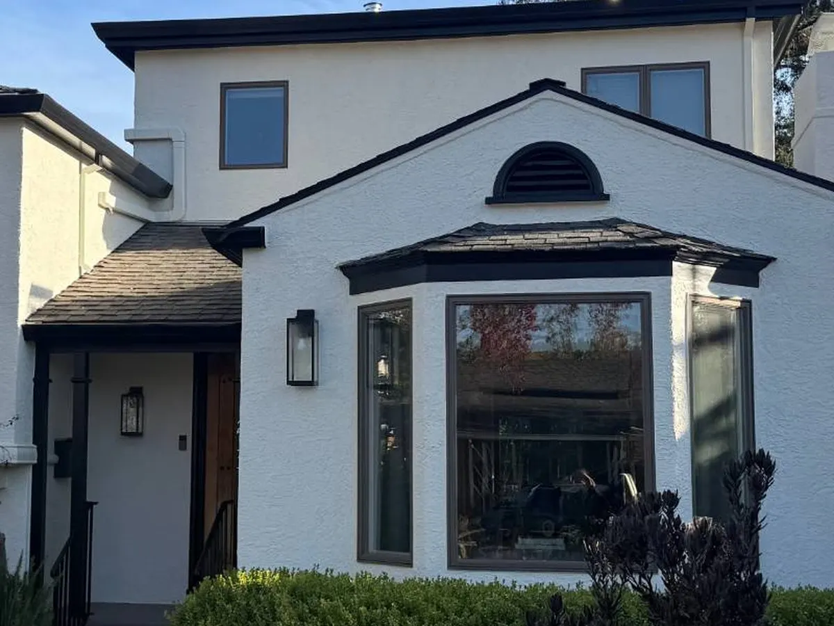 Same house front painted warm white with black trim