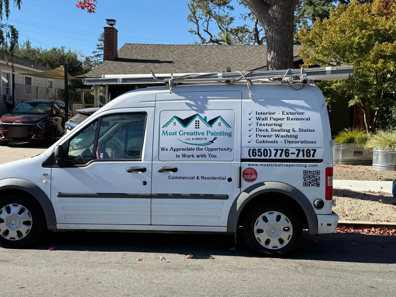 Most Creative Painting's white work van with the company logo and services on the side